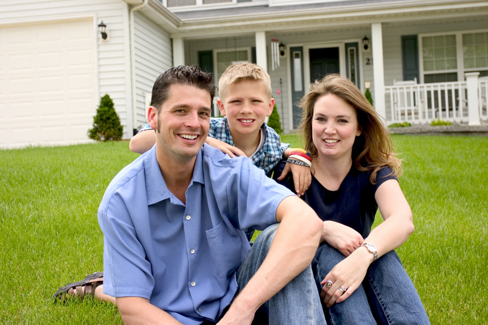 Young Family in Front of Home